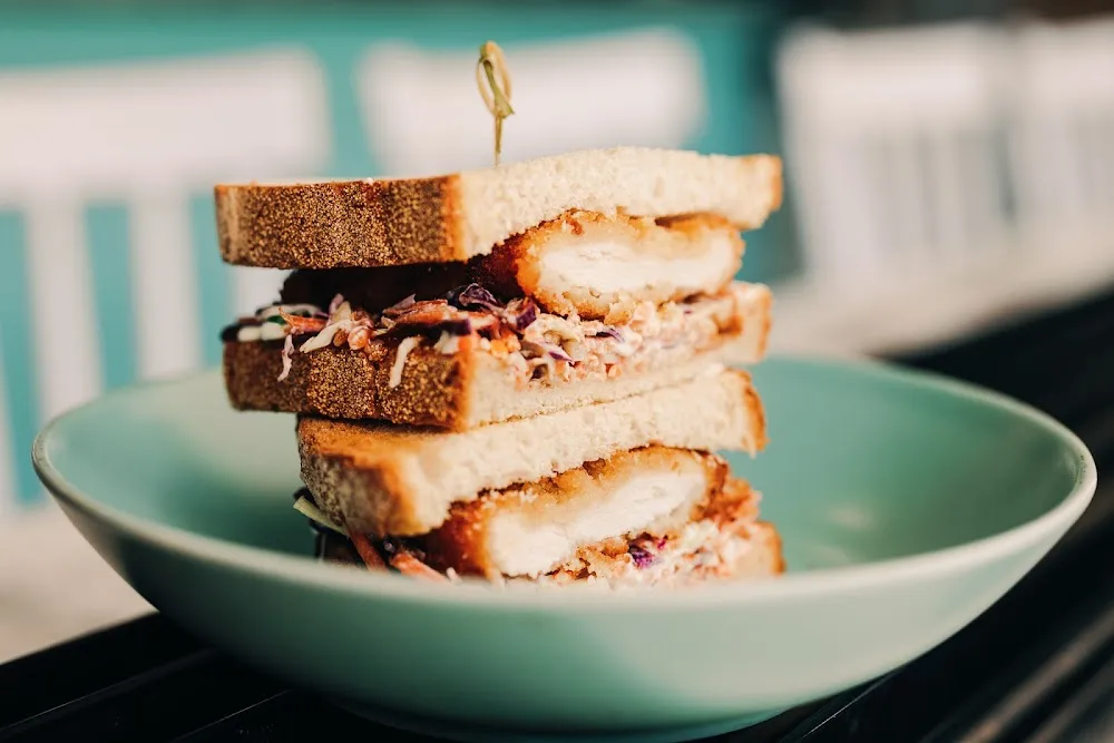 Stacked katsu sandwich served in a pale green bowl